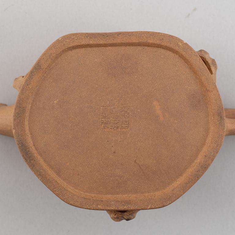 A Yixing pottery tea pot with cover, China, 20th Century, with seal mark.