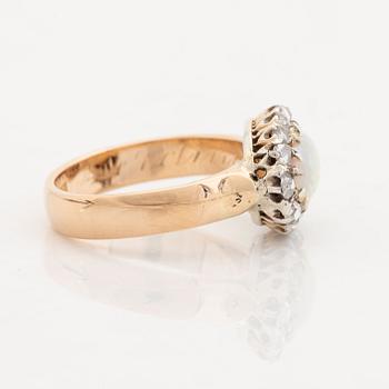 An 18K gold and opal ring set with rose-cut diamonds.