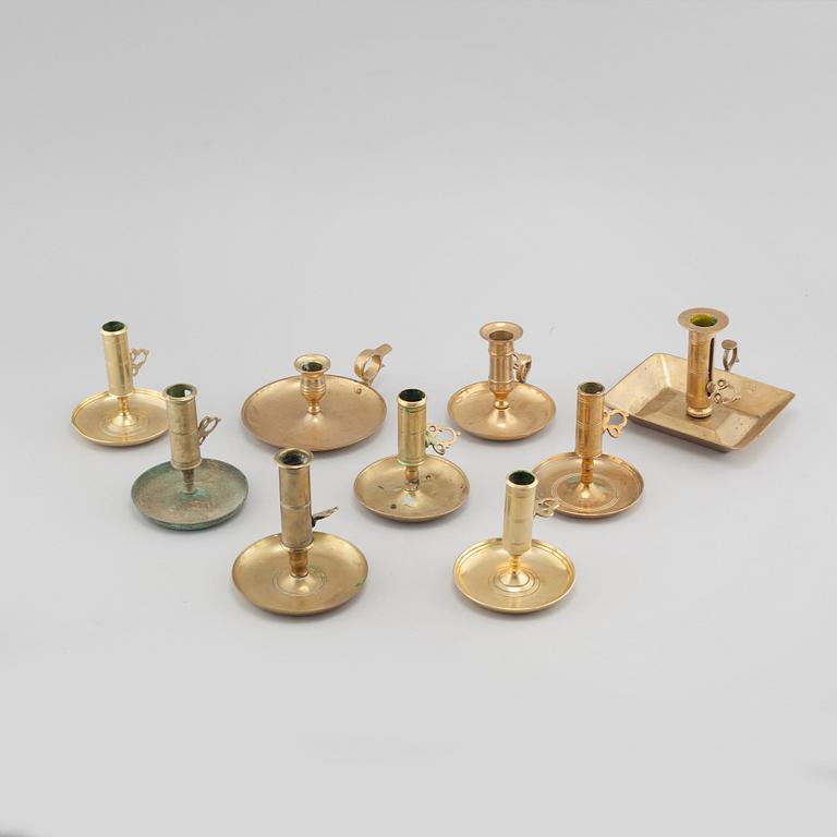 Nine brass candlesticks, 20th century.