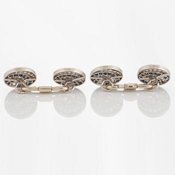 A pair of cufflinks in platinum and 18K white gold set with diamonds of various cuts and sapphires.