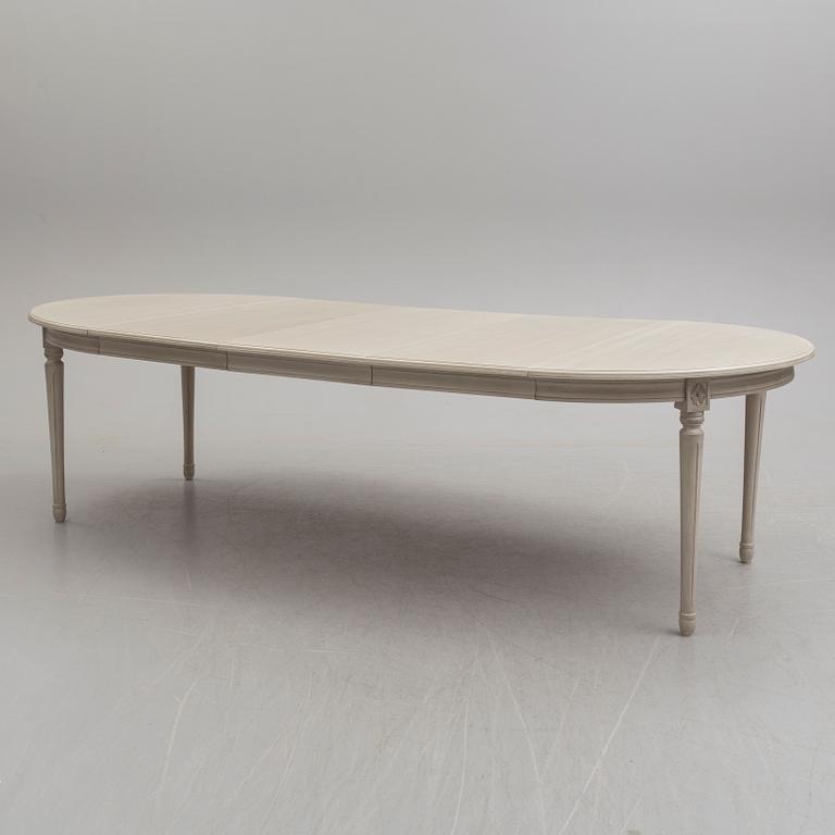 A second half of the 20th century Gustavian style dining table with two armchairs and 8 chairs.