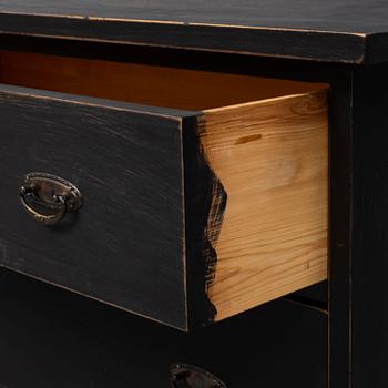 a chest of drawers from the first half of the 20th century.