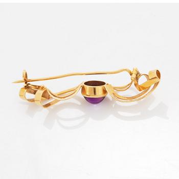 A pair of earrings and a brooch.