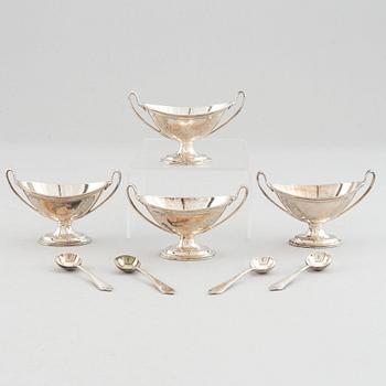 Four silver salt cellars with spoons, Edward Barnard & Sons Ltd, London, England, 1880.