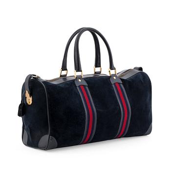 GUCCI, a blue suede and leather weekendbag.