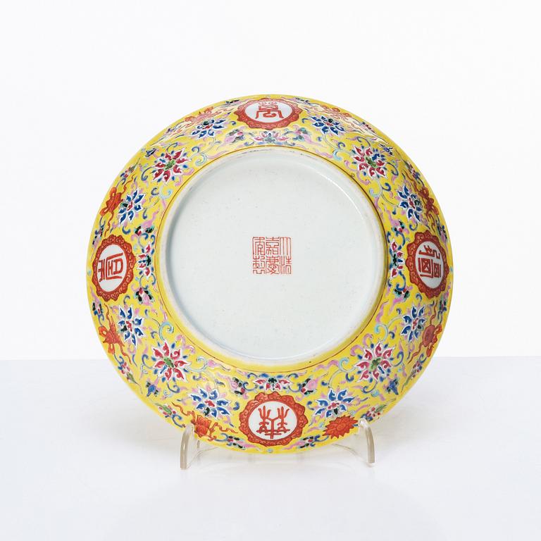 A Chinese famille rose yellow ground 'bat' dish, Qing dynasty with Jiaqing mark.