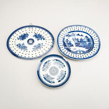 A set of two Chinese blue and white 18th century plates and strainer.