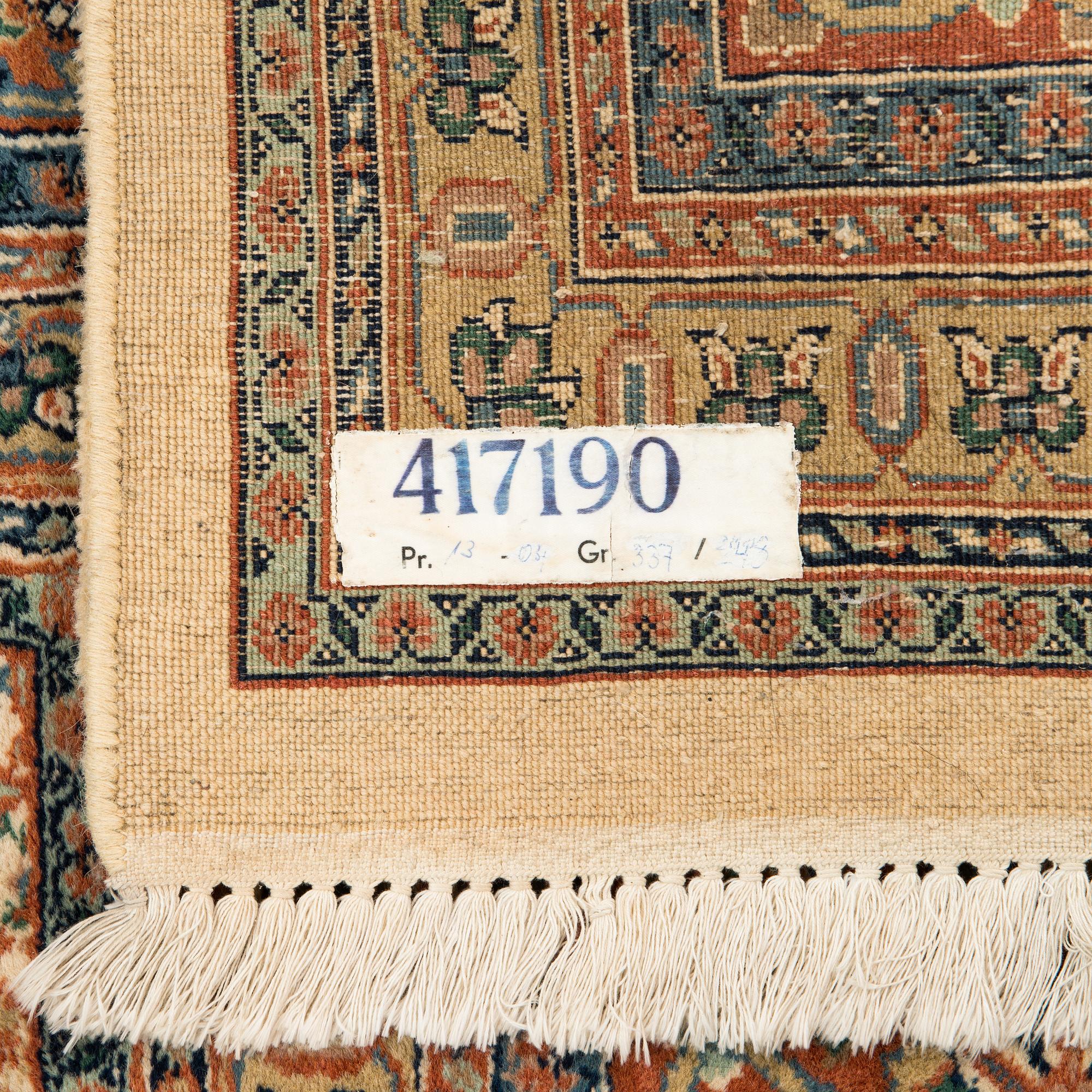 An oriental carpet. Circa 345x245 cm.