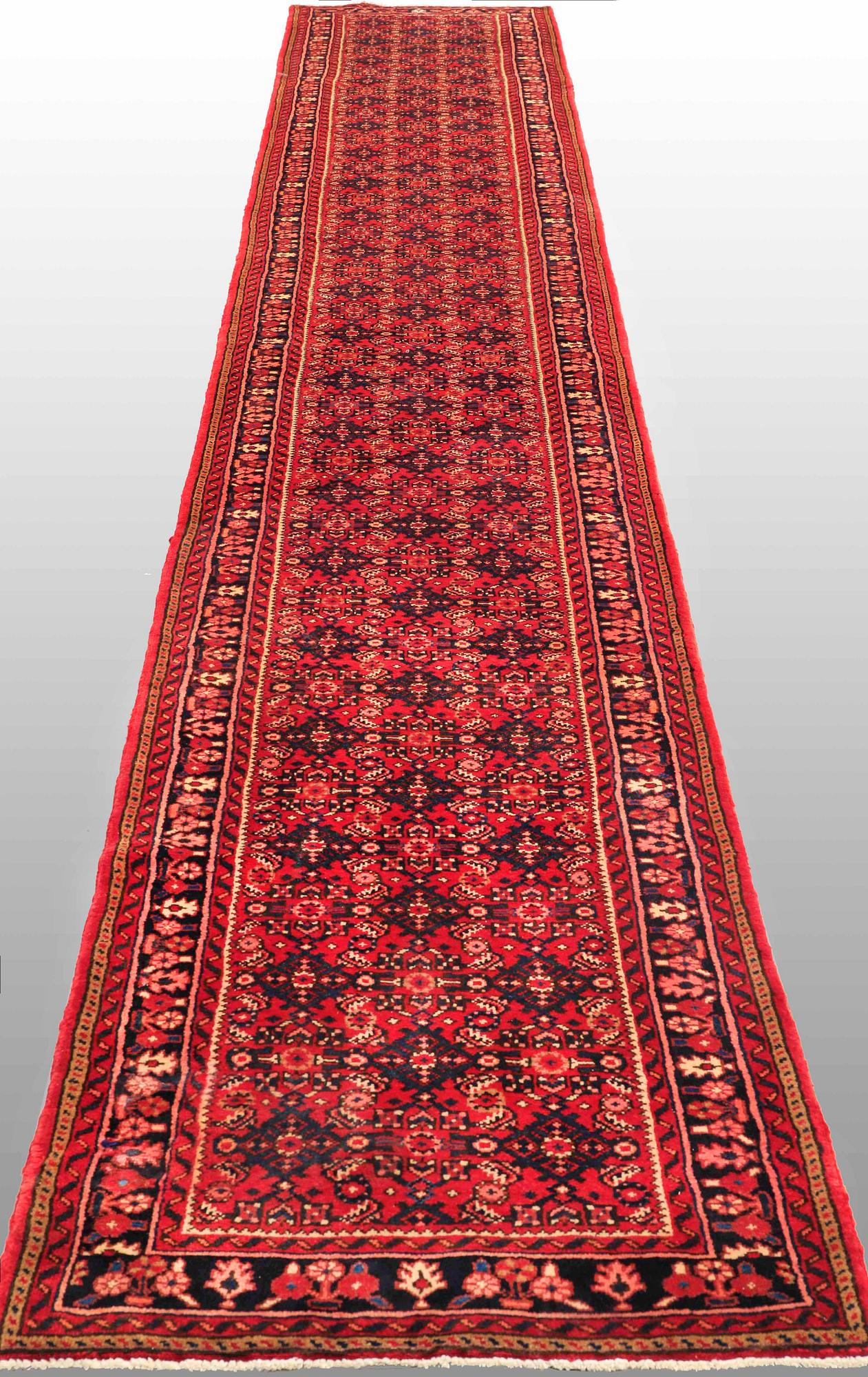 A Hosseinabad runner, c. 605 x 84 cm.