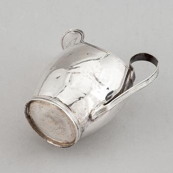 Beaker, silver 1835, cream-jug, silver 1826 and bread-plate, silver 1952.