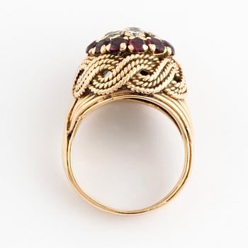 An 18K gold ring set with round brilliant-cut diamonds and rubies.