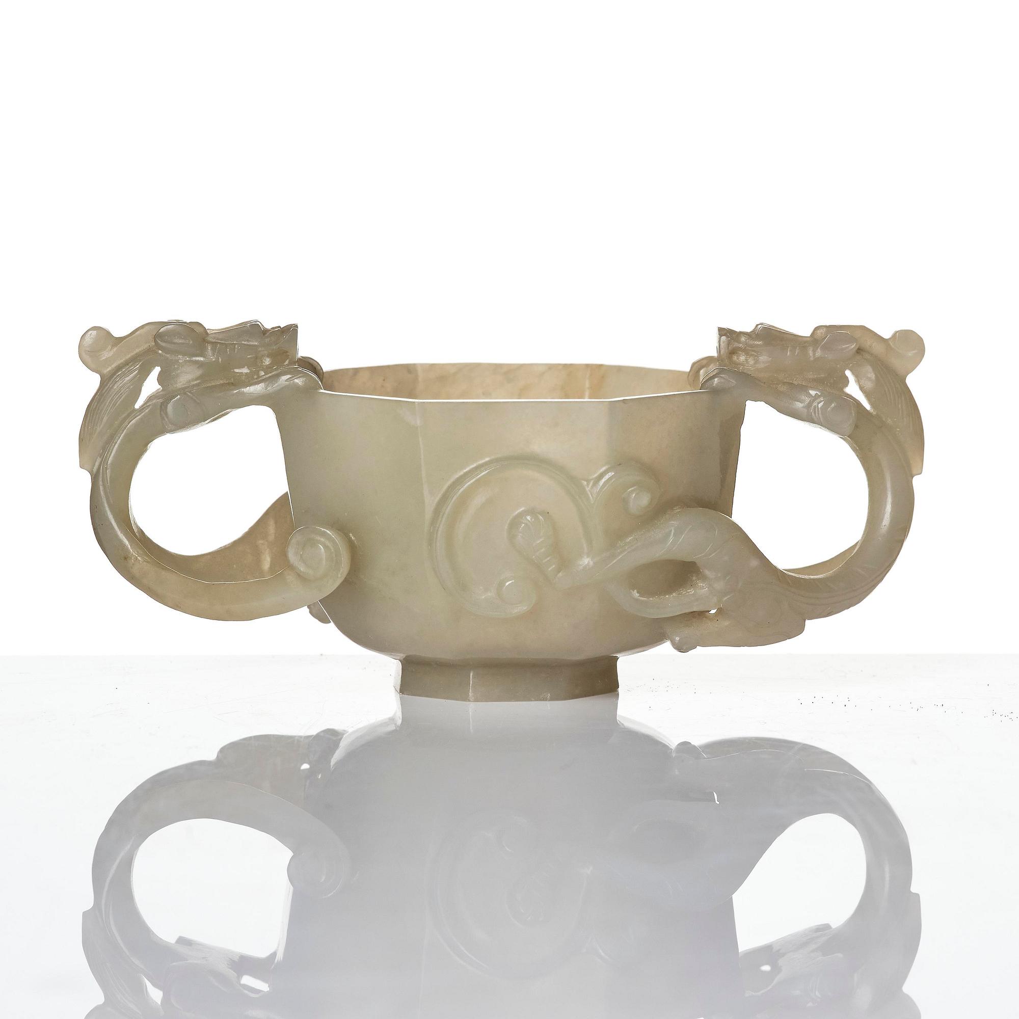 A carved nephrite cup with 'chilong' handles, late Qing dynasty/early 20th century.