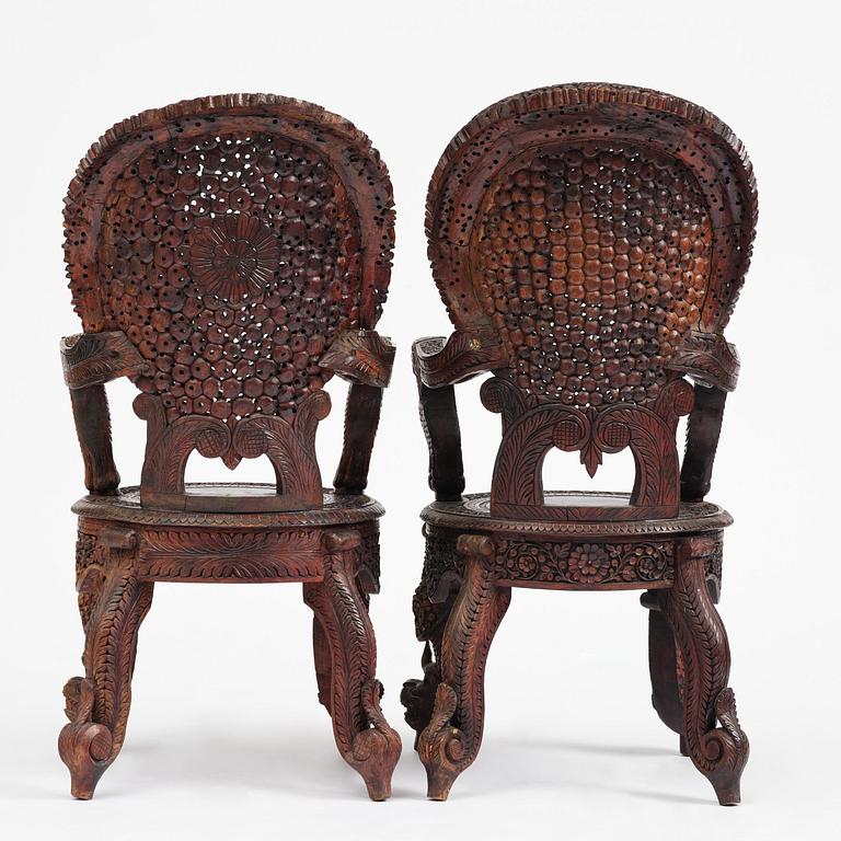 A pair of carved 'blackwood' armchairs, Bombay presidency, British Raj, circa 1880.