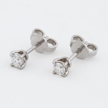 A pair of brilliant cut diamond earrings.