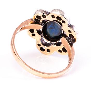 A 10-11K gold ring with a cabochon cut sapphire and old cut diamonds ca. 0.35 ct in total.