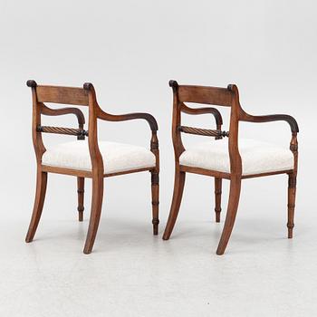 A set of 10 mahogany chairs and 2 armchairs, Regency style, from around the year 1900.