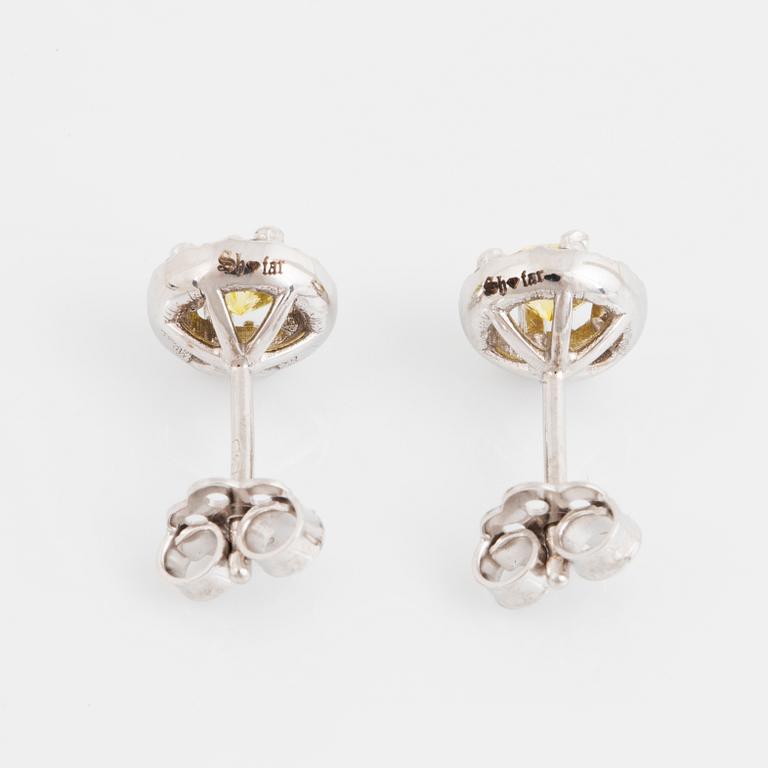 A pair of 18K gold earrings set with color treated yellow diamonds.