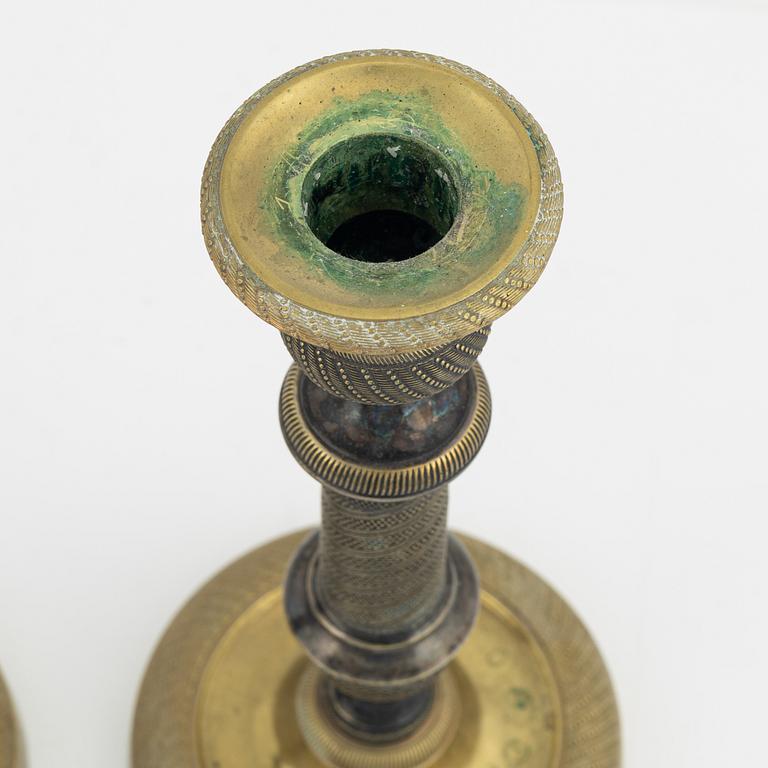A pair of bronze Empire style candlesticks, 20th Century with older parts.
