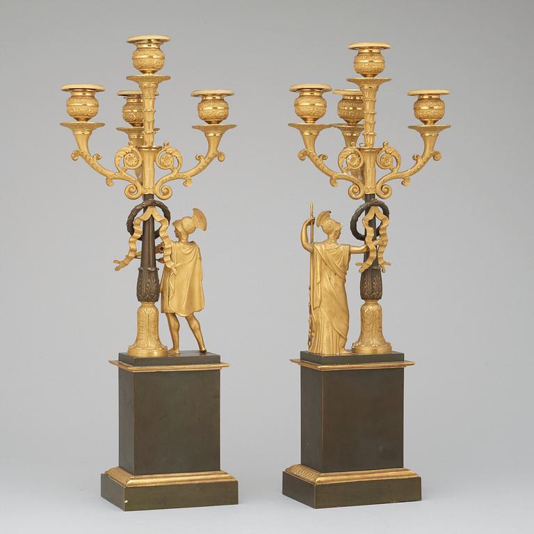 A pair of French Empire early 19th century gilt and patinated bronze four-light candelabra.