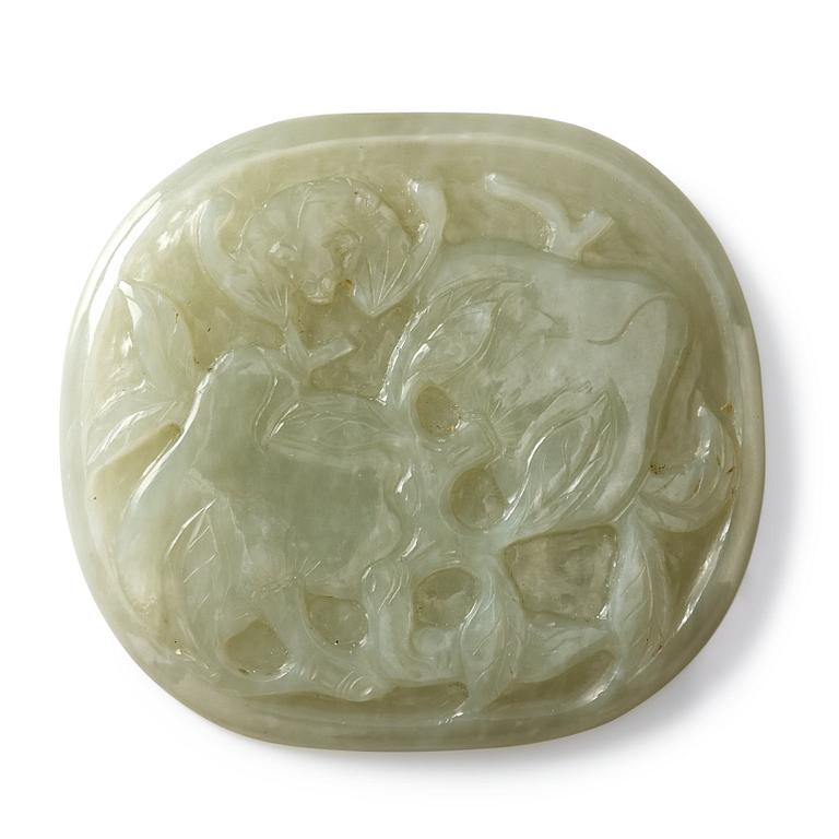 A nephrite placque decorated with peaches and a bat, late Qing dynasty.