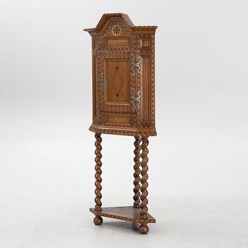 A corner cabinet, late 19th century.