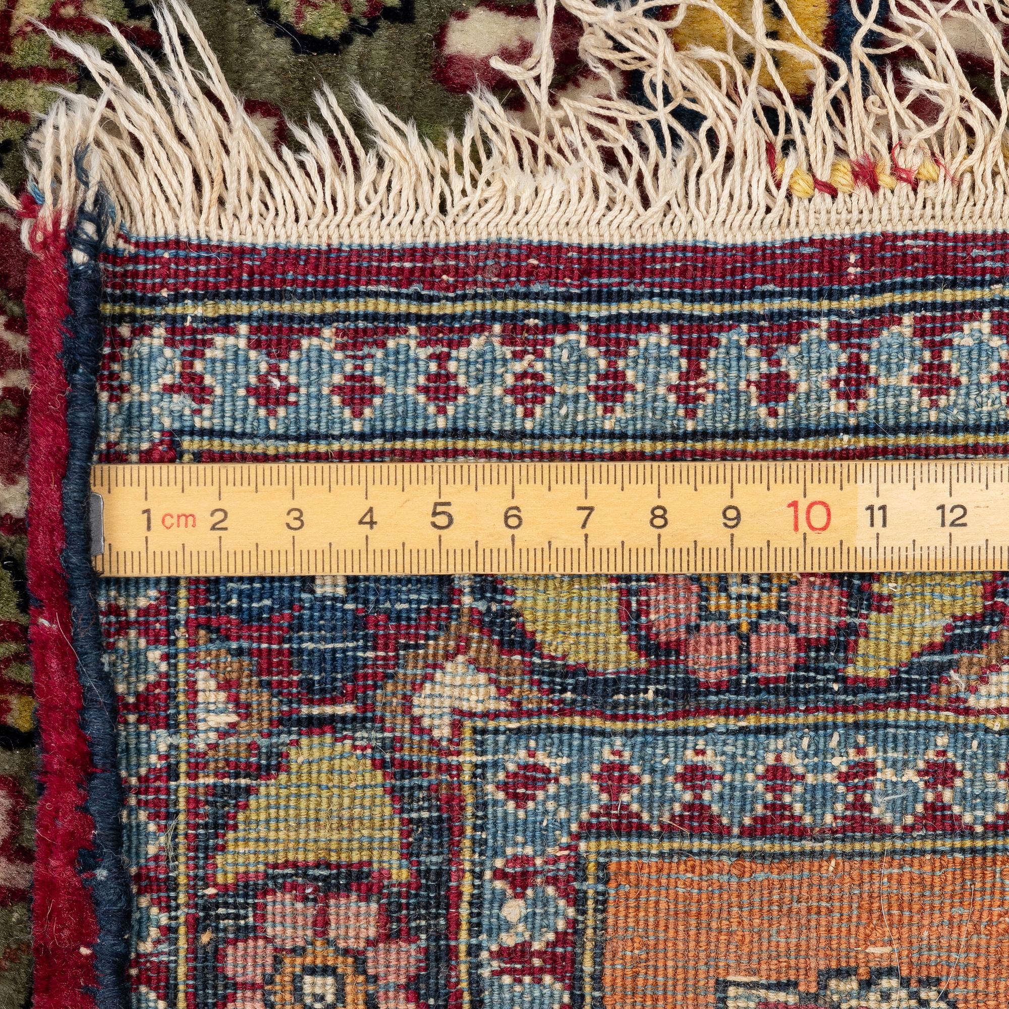 An antique Mobarekeh rug, central Persia, c. 230 x 130 cm.