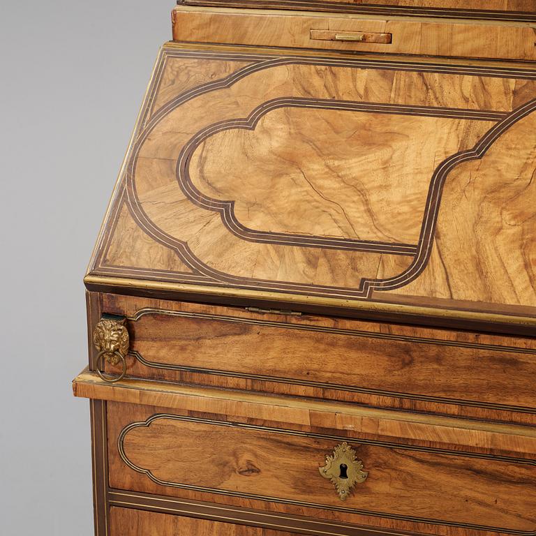 A late Baroque walnut veneer cabinet, mid 18th century.