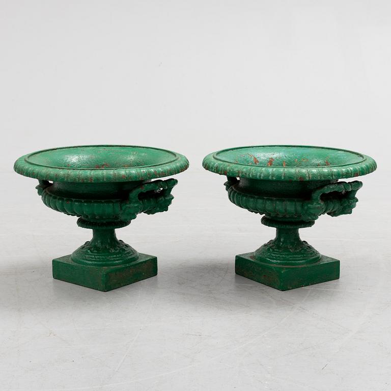 A pair of cast iron garden urns by Husqvarna, circa 1900.