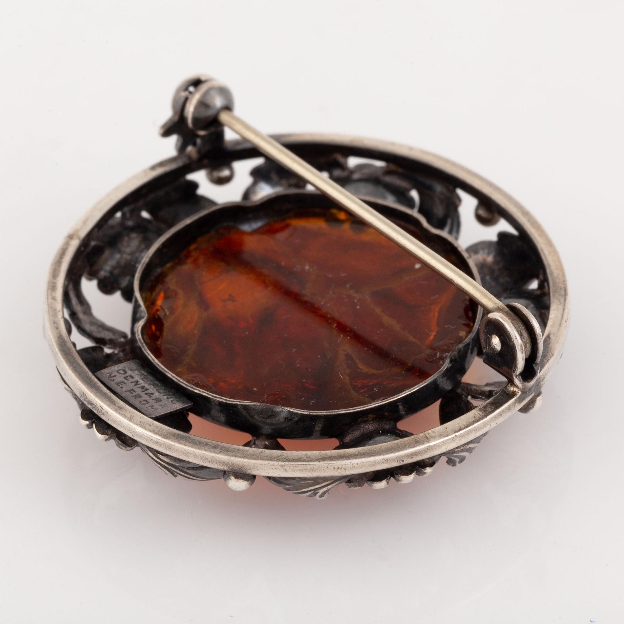 An NE From silver and amber brooch.