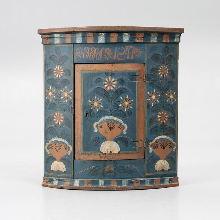 A folk art corner cabinet from Delsbo, Hälsingland dated 1847.