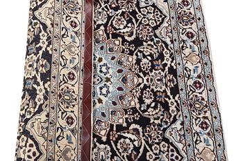 A Nain rug, part silk, 9 laa, c. 210 x 119 cm.