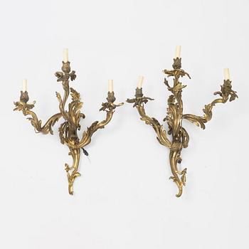 A pair of gilt-brass Louis XV-style wall-lights, circa 1900.