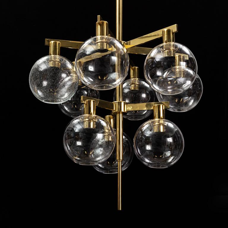 A brass chandelier with glass globes by Hans Agne Jakobsson, Markaryd.