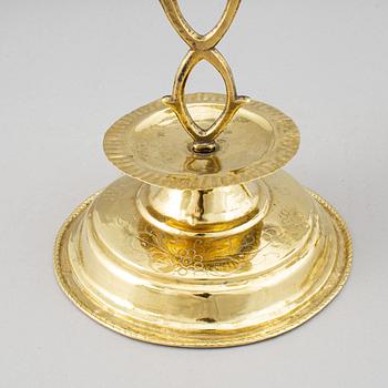 A pair of brass candelabra for two candles "Blekingestakar and a pair of brass cups, 1800/1900.