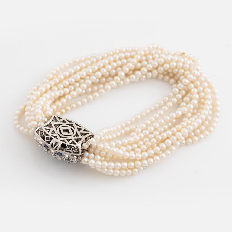Cultured pearl bracelet, eleven strand, clasp white gold with sapphire and diamonds.