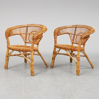 A pair of rattan chairs.