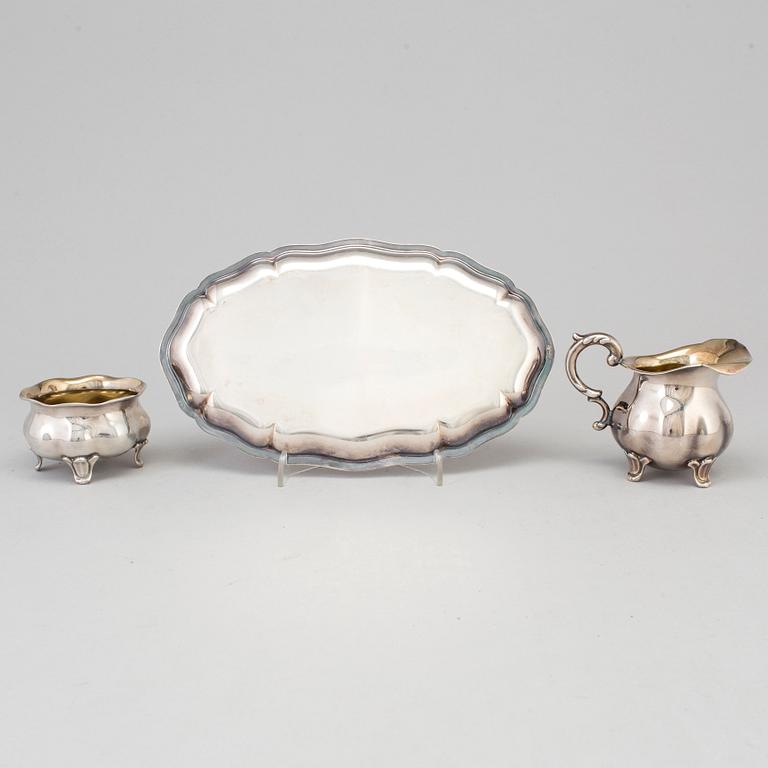 A parcel-gilt rococo style creamer, sugarbowl an a tray from Wilkens, Germany.