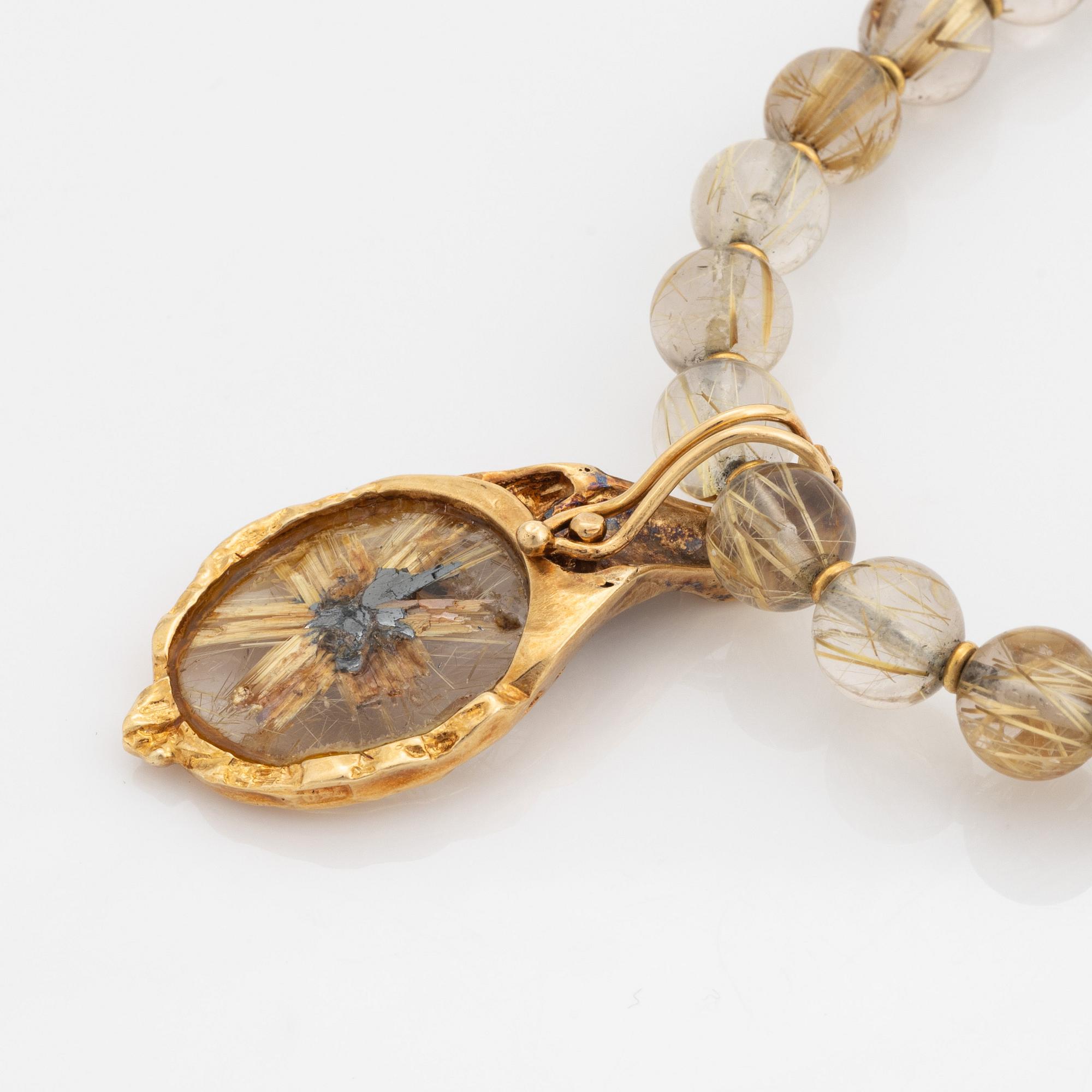 Arne Blomberg, pendant with chain, rutile quartz, gold and diamonds.