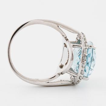 A aquamarine and brilliant cut diamond ring.