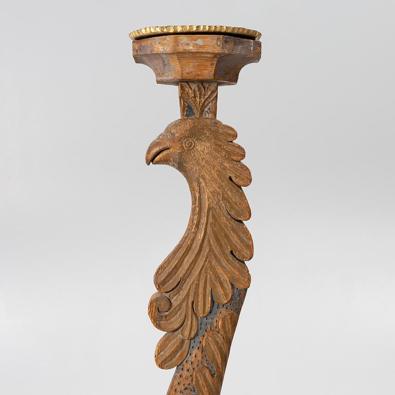 A carved wood floor candlestick, circa 1900 composed of 18th century elements.