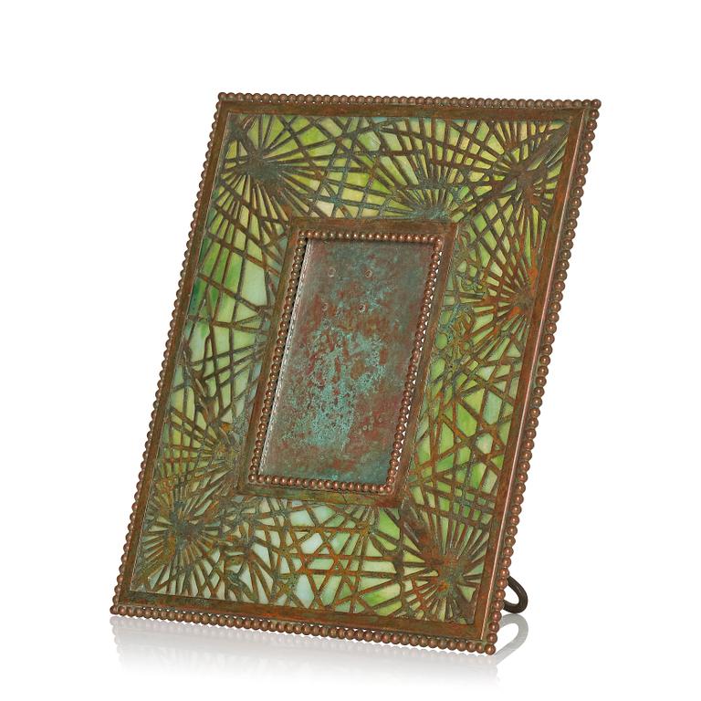 Louis Comfort Tiffany / Tiffany Studios, an Art Nouveau bronze and marbled "Pine needles" glass frame model "948", New York.