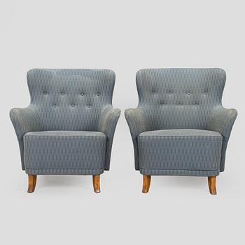 A pair of mid-20th century armchairs.
