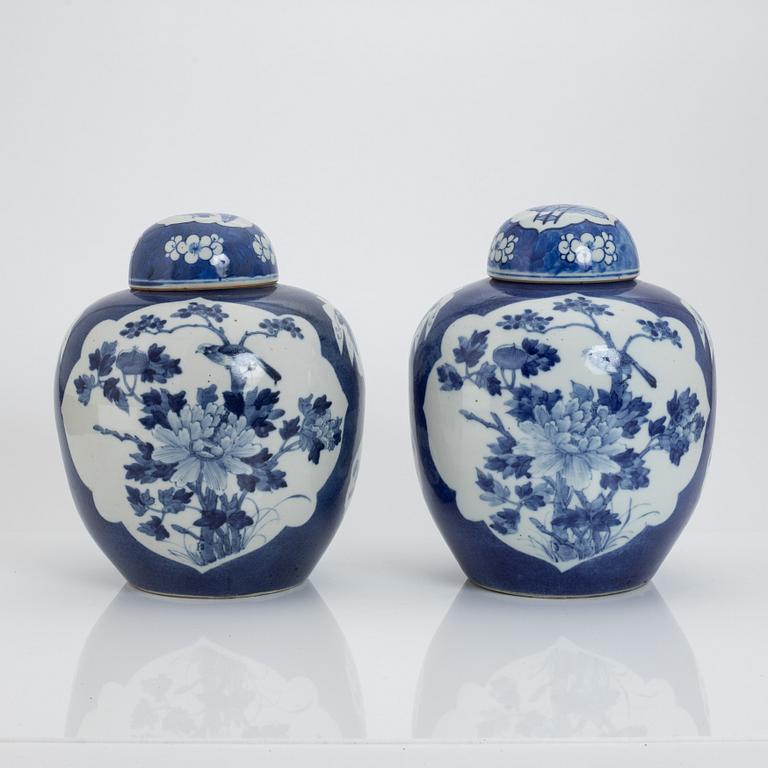 A pair of Chinese blue and white jars with covers, 20th century.