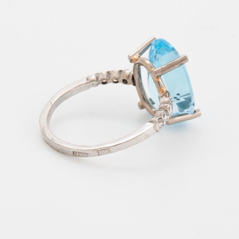 Oval faceted blue topaz and brilliant-cut diamond cocktail ring.