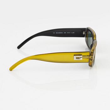 Gucci, a pair of yellow sunglasses.