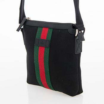 Gucci, a "Techno Canvas Web Messenger" bag.