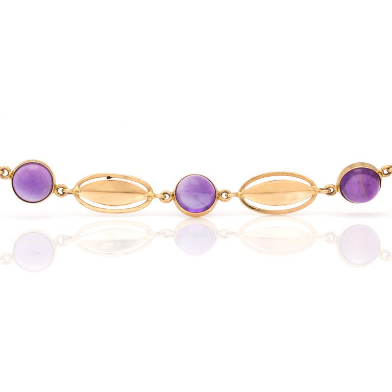 A bracelet with round, cabochon-cut amethysts.