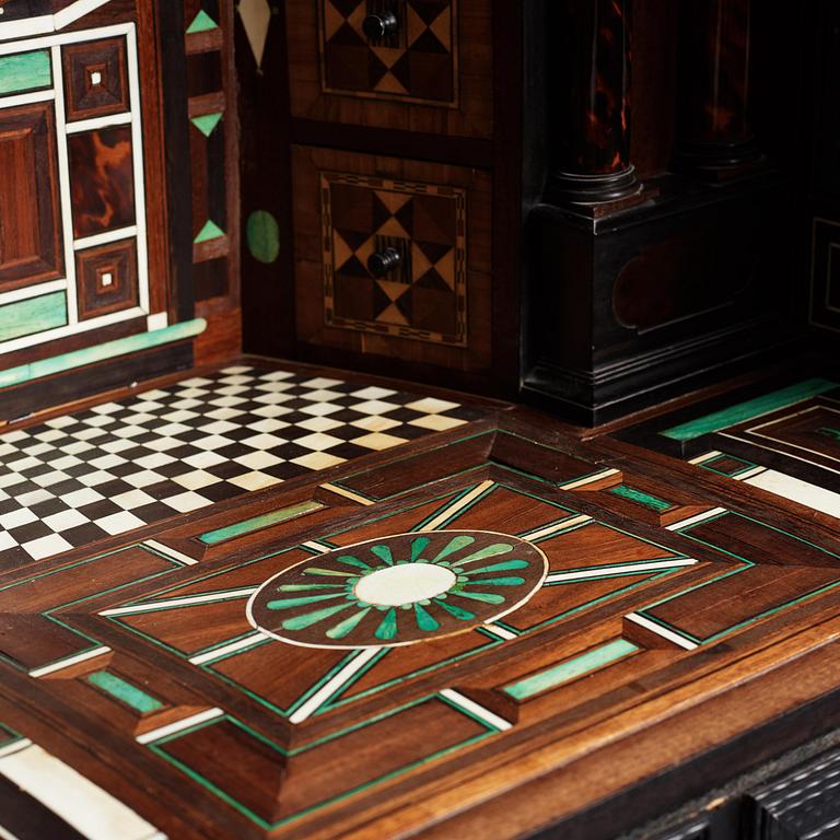 A Louis XIV and Louis XIV-style carved ebony, ivory and tortoiseshell-inlaid cabinet on stand, 17th and 19th century.