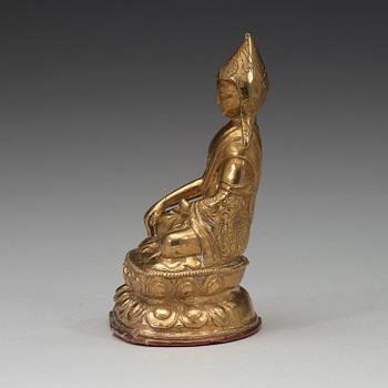 A Tibetan copper alloy figure of a Lama, circa 1900.