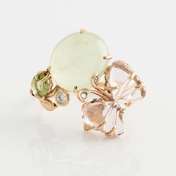 Ring with cabochon-cut prehnite, cut tourmaline in the shape of a butterfly, peridot, and brilliant-cut diamonds.